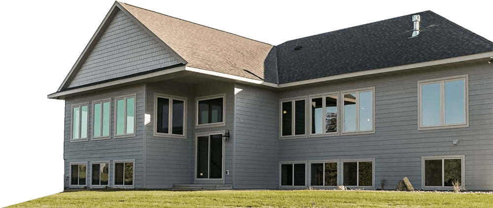 About Banner Image- Rear elevation of an egress basement ranch. Abundance of windows for rear property views. Large gable end with hand split shake siding. Roof line cantilevers and covers the patio.