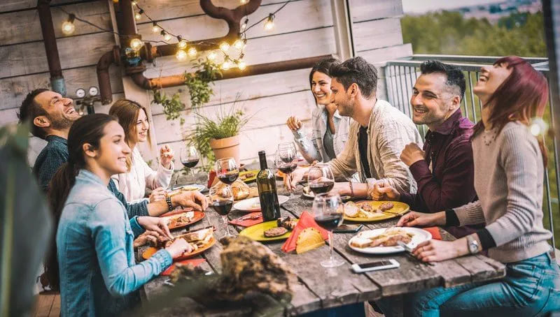 Friends gathering around picnic table image