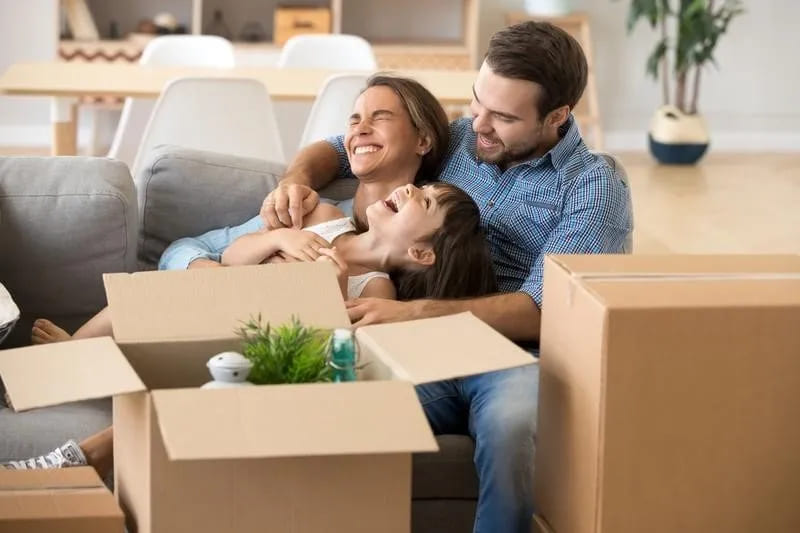 Family laughing as they pack