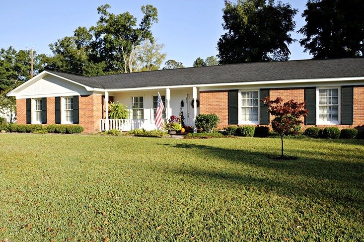 Brick home with American flag on front porch